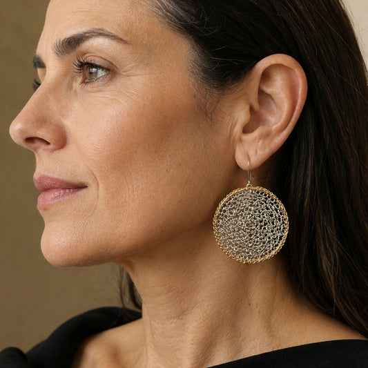 Model wearing Crochet Eclipse hand-crocheted sterling silver earrings on brass hoops by JYOCO