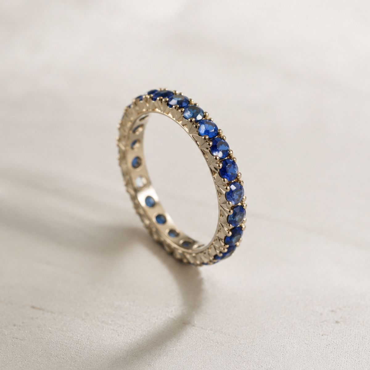Ring with blue gemstones on a light gray background