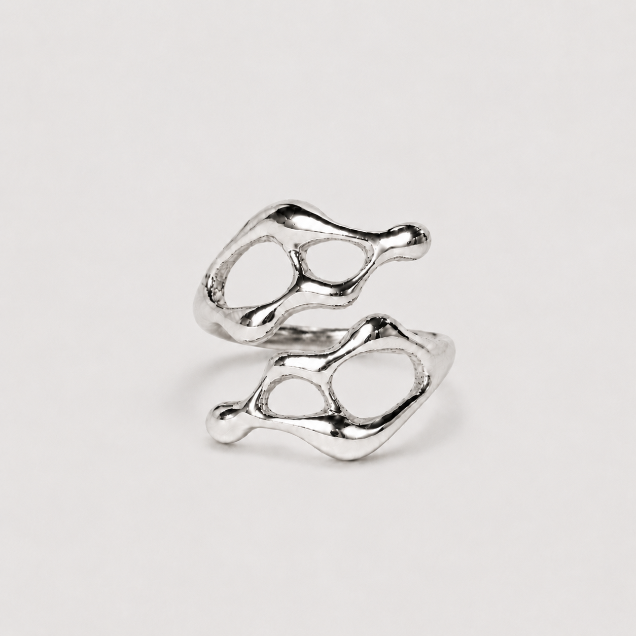 Silver ring with a unique design on a light gray background