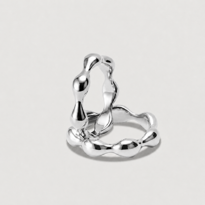 Silver ring with a modern design on a light gray background