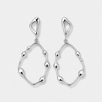 Pair of silver earrings on a light gray background