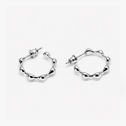 Pair of silver hoop earrings on a white background