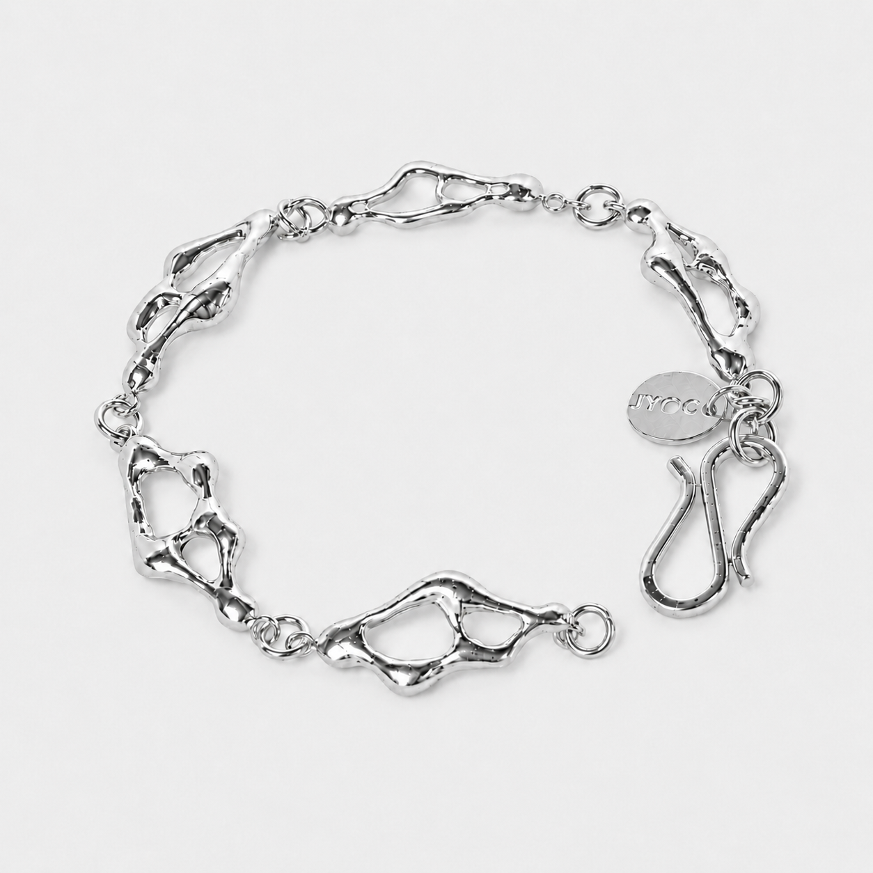 Silver bracelet with a textured design on a light gray background