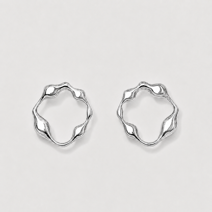 Pair of silver hoop earrings on a light gray background